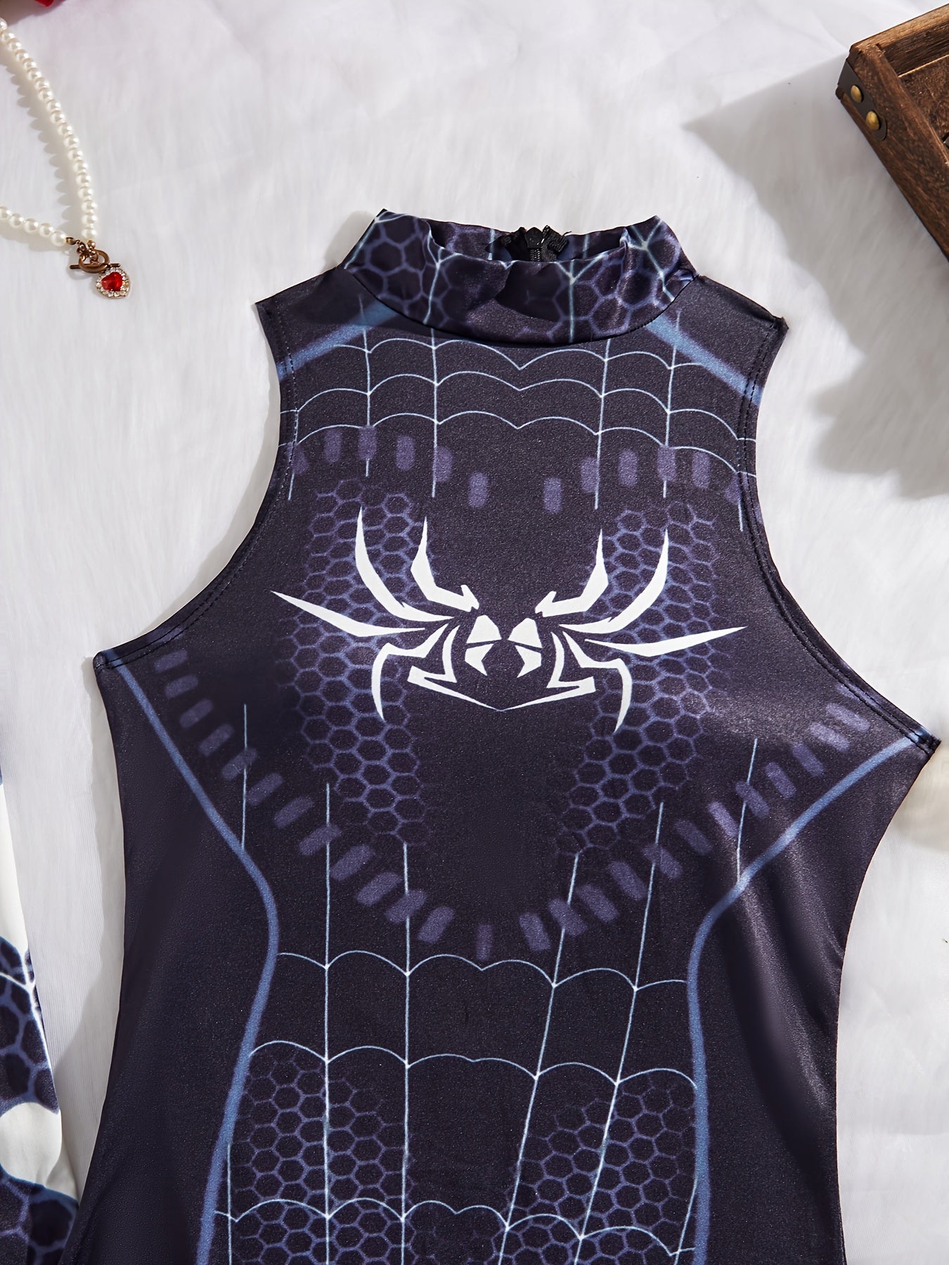 Sexy lingerie set includes spider themed bodysuit, socks, and costume.