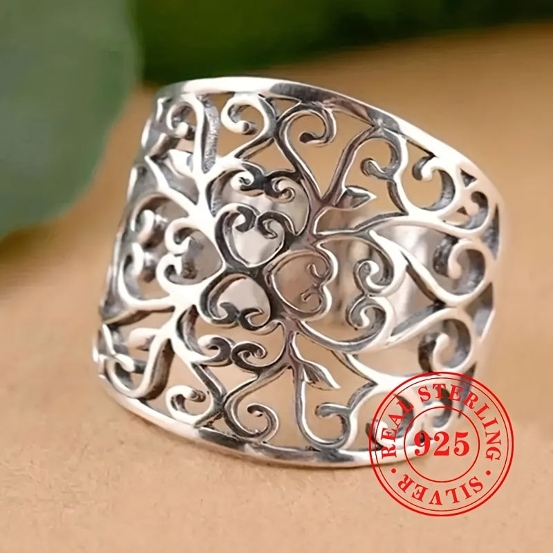 This elegant and one-of-a-kind lady's ring is crafted from high-quality S925 sterling silver, weighing 5.7 grams. It showcases a stunning hollowed-out floral vine design on the wide face, highlighting the exquisite craftsmanship behind its creation.