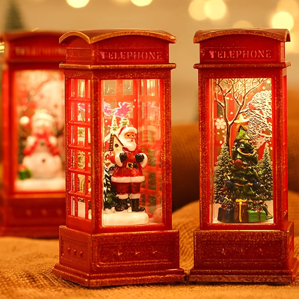 Festive Christmas phone booth decoration featuring Santa, snowman, and tree scenes. Battery-operated with illuminated red cabinet for holiday display.