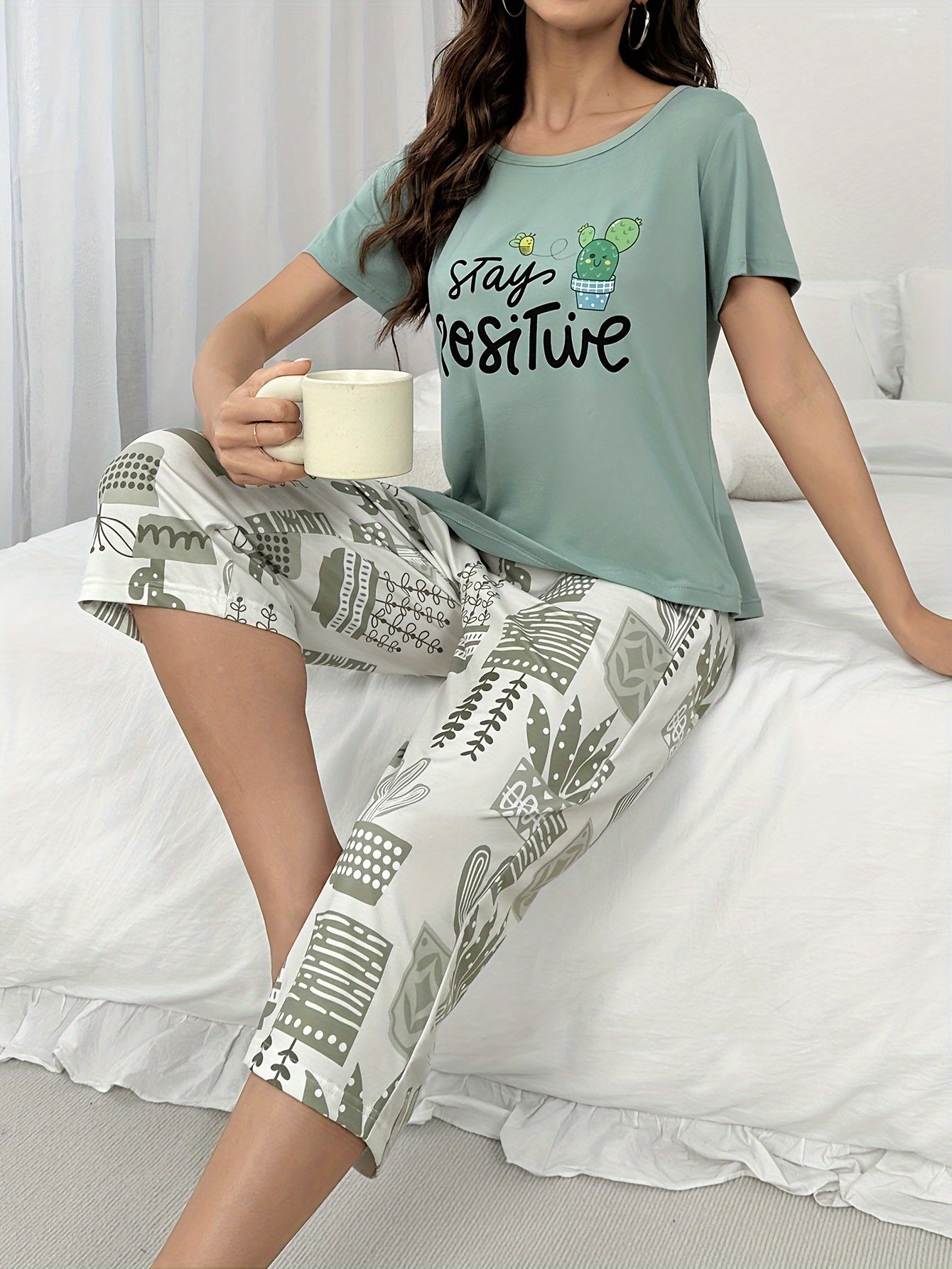 Women's short sleeve pajama set with letter print top and capris pants. Perfect for sleepwear or lounging.