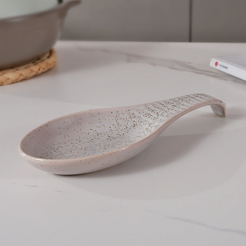 A single piece Ceramic Spoon Rest, beautifully handcrafted Soup Ladle Holder, featuring a Modern Country Style design. Perfect for organizing kitchen utensils, this European Vintage Creative Reaction Glaze piece comes with a practical Ladle Stand for