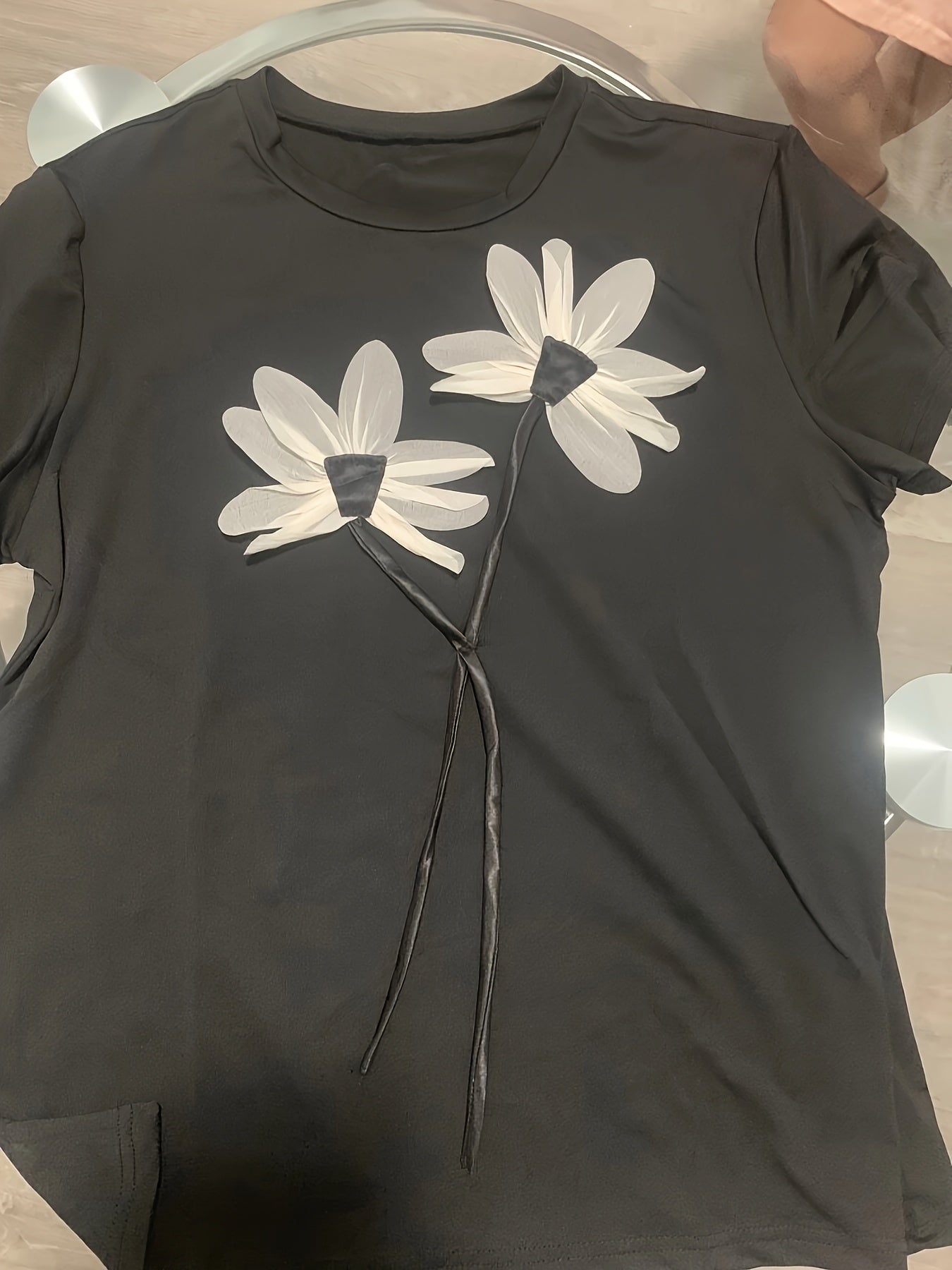 Floral applique plus size t-shirt for women. Made of stretchy polyester-spandex blend. Round neck, short sleeve, machine washable. Suitable for summer casual or formal wear.