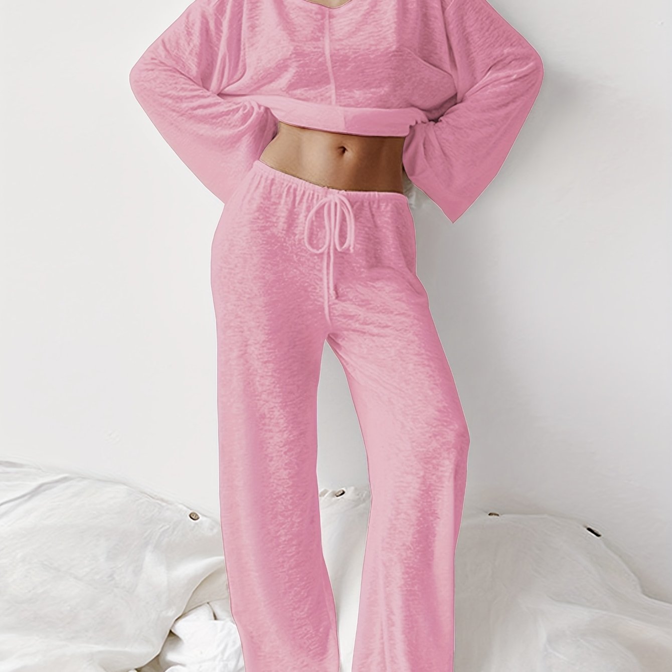 Two-piece set of loose home clothes for women made with micro-transparent fabric featuring a round neck, long sleeves, and trousers.