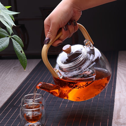 Stylish glass teapot with bamboo handle, ideal for blooming and loose leaf tea. Heat resistant and includes tea infuser. Perfect Christmas gift.