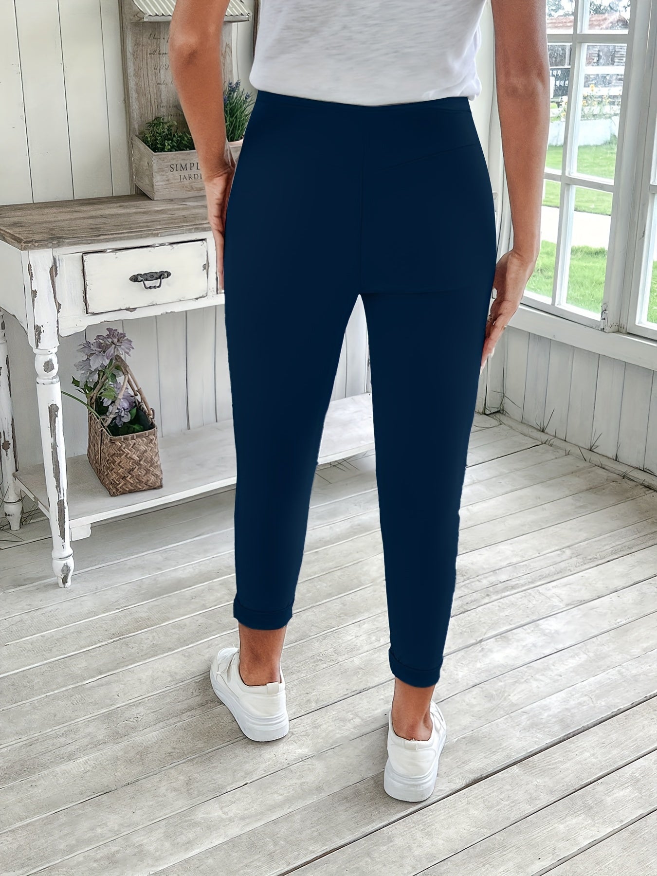 Navy blue drawstring jogger pants for women. Made of stretchy polyester with pockets. Machine washable. Comfortable and adjustable, perfect for all seasons.