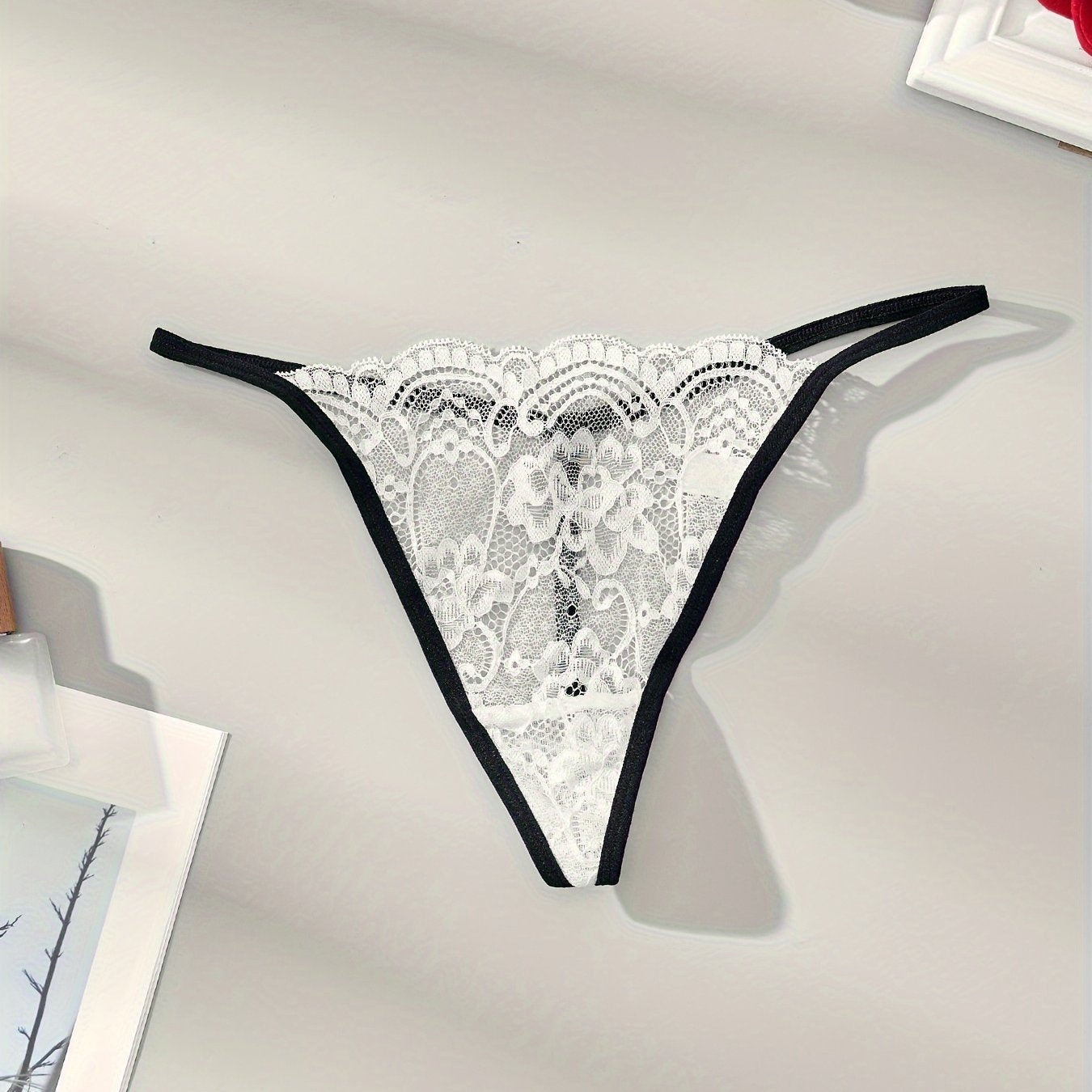 Lace thong with low rise and thin straps for seductive style.