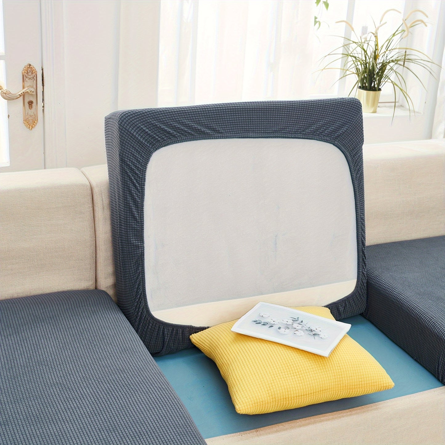 Durable sofa cover protects furniture from spills and stains.