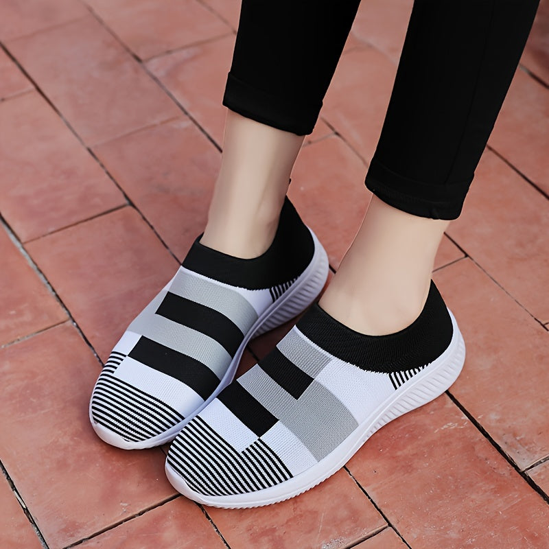 Breathable mesh slip-on sneakers for plus size women in pink, gray, and white plaid with soft sole and round toe design, suitable for all seasons.