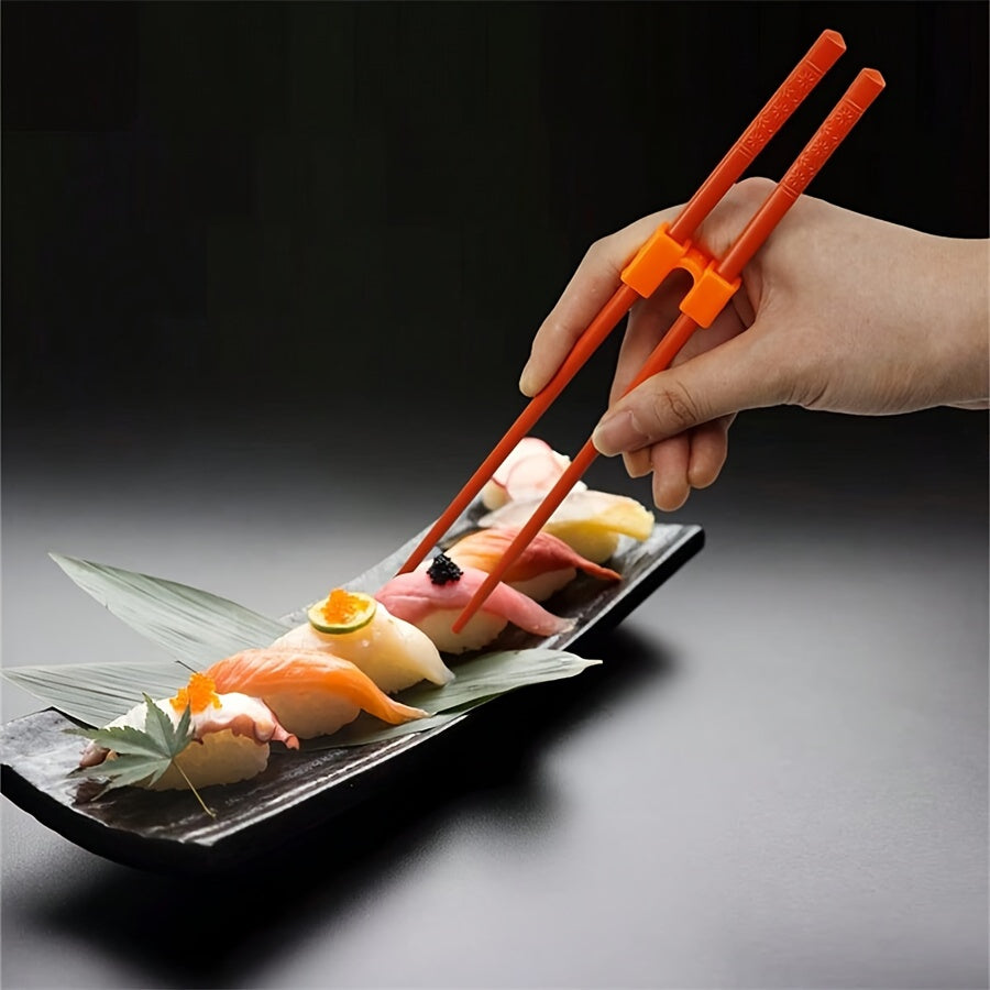 Set of 4 chopstick grip aids with interchangeable plastic connectors, ideal for adults, beginners, and learners. Dishwasher safe. Chopsticks not included.