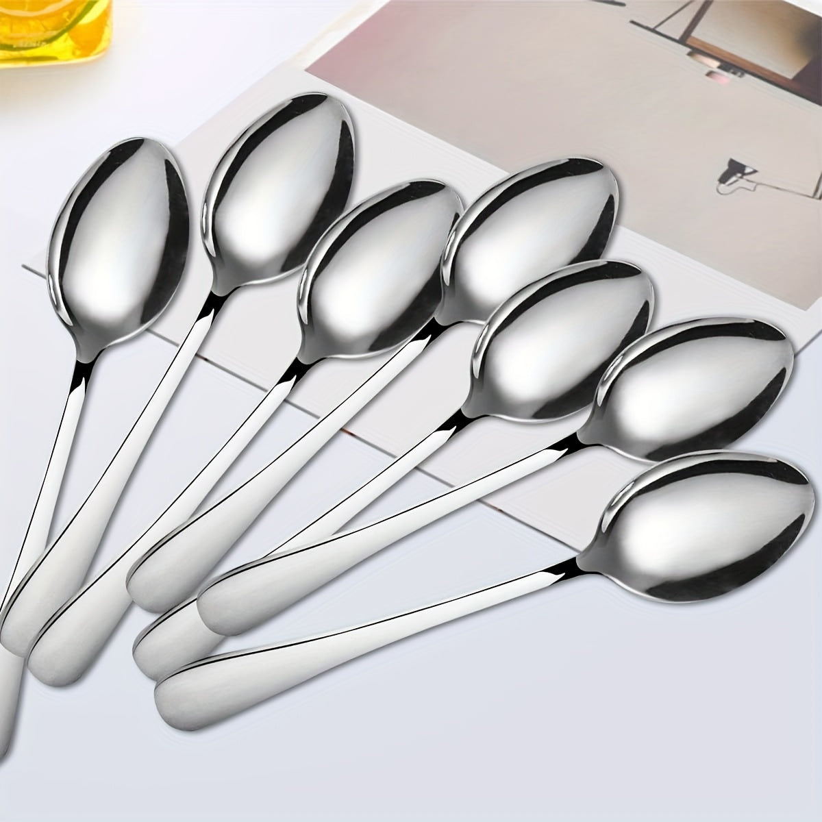 12-piece stainless steel dessert spoon set, 13.69cm, sleek design with black accents and polished finish. Perfect for home, kitchen, restaurants, and afternoon tea. Ideal for ice cream, coffee, and tea.