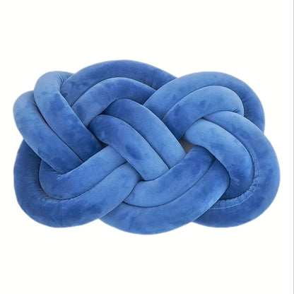 Knotted throw pillow for home decor, suitable for bed or sofa.