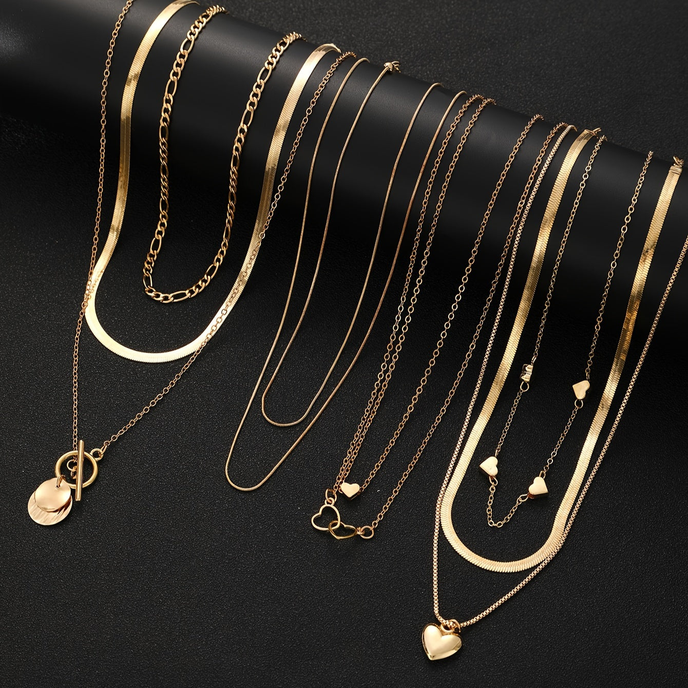 This stylish necklace set features 10 pieces with vintage heart and geometric pendants, complete with a snake chain and OT clasp. Ideal for everyday wear, special occasions, and gifting, this pendant necklace is the perfect accessory.