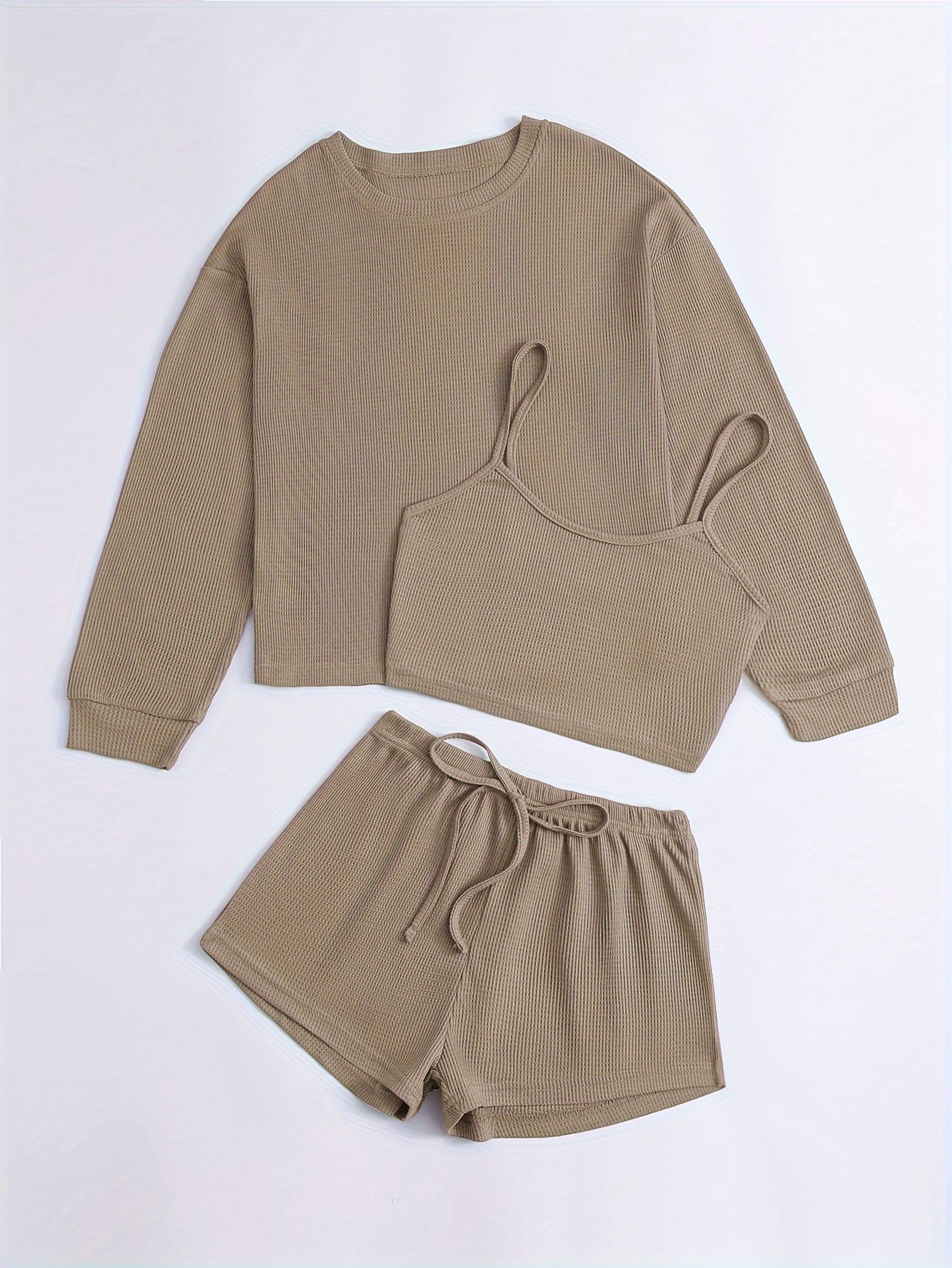 Women's loungewear set with waffle texture, long sleeve top, crop cami, and elastic shorts.