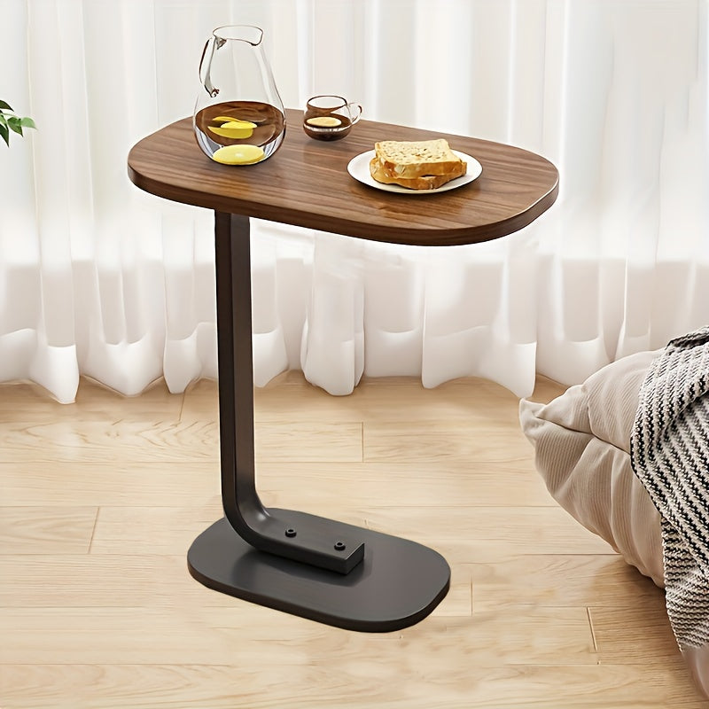 Modern C-shaped sofa side table made of walnut wood and iron, with a sturdy black frame. Compact and durable design suitable for various spaces.