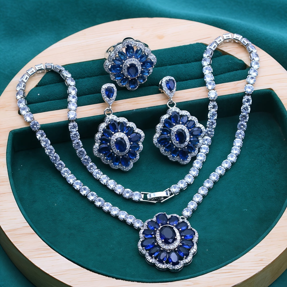 Stunning bridal jewelry set featuring 4 pieces made of luxurious white gold plated copper and adorned with blue cubic zirconia. Set includes a necklace, earrings, and an adjustable ring, ideal for weddings and special events.