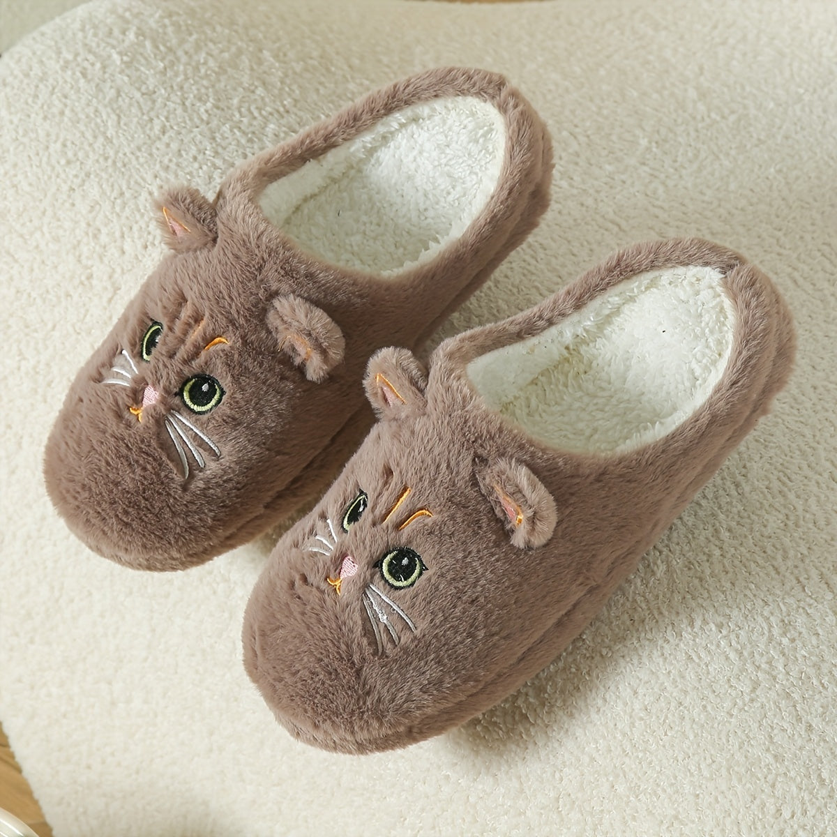 Women's cute cartoon black cat slippers with big eyes and ears, soft, warm, non-slip indoor house slip-ons made of fabric with TPR soles.