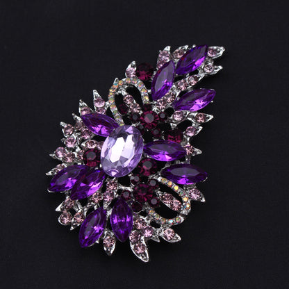 Crystal embellished fashion accessory - vintage rhinestone brooch pin featuring an irregular flower design