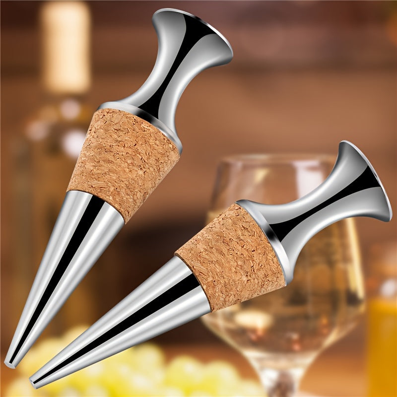 Two silver wine stoppers with wooden plugs.