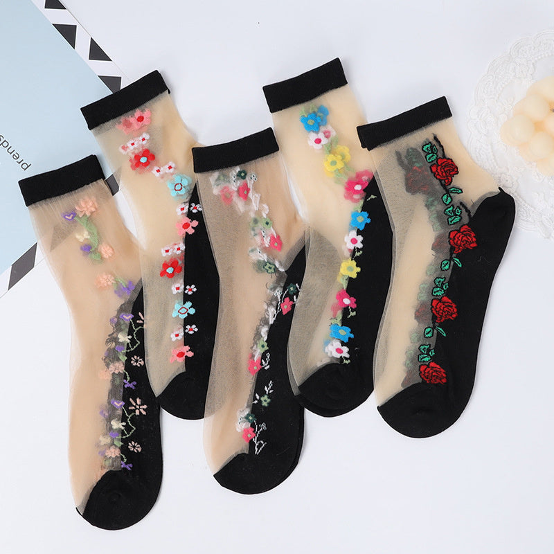 5 pairs of women's floral crystal mesh short socks in black with multicolor flower patterns. Made of ice silky fiber that is breathable and lightweight. Hand wash only. Cute socks.