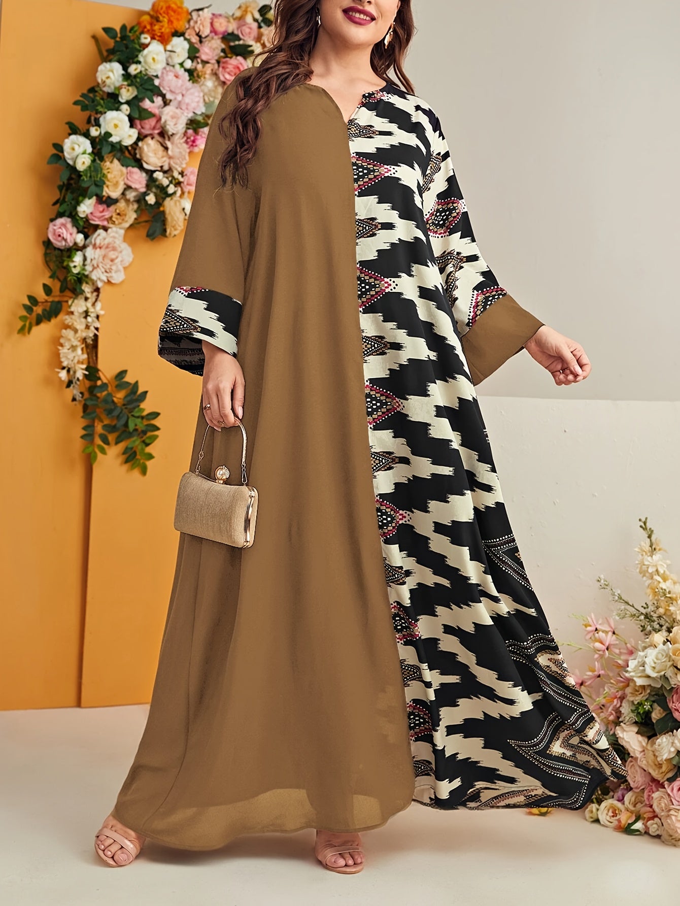 Elegant plus size geometric kaftan dress in black and beige houndstooth pattern with floral accents. Made of polyester, machine washable, with V-neck, long sleeves, and flowing silhouette