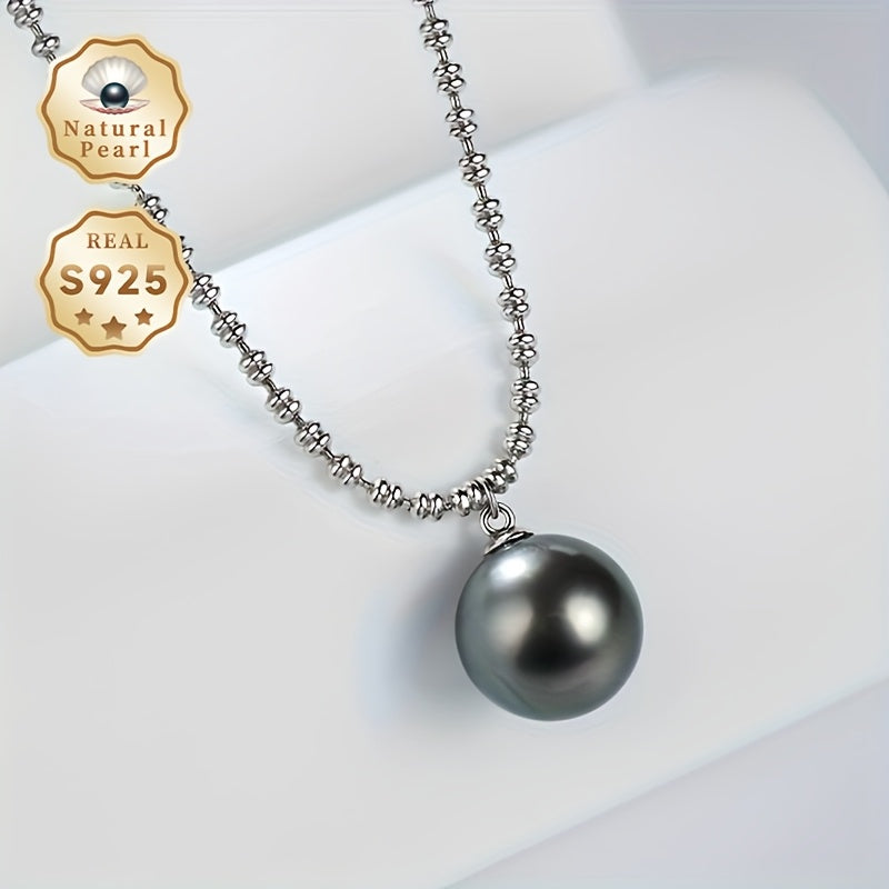 Elegant Vintage-Inspired Black Pearl Pendant Necklace for Women - Featuring Large 10-11mm Round Sea Pearls on an S925 Silver Chain. Perfect June Birthstone Gift presented in a Luxury Red Gift Box. Inspired by Polynesian design, showcasing the Natural