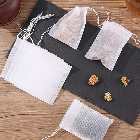 100 pieces of disposable drawstring tea bags made of non-woven material. These food-safe filter bags are perfect for brewing Chinese medicine, seasoning, straining soup, and separating residue.