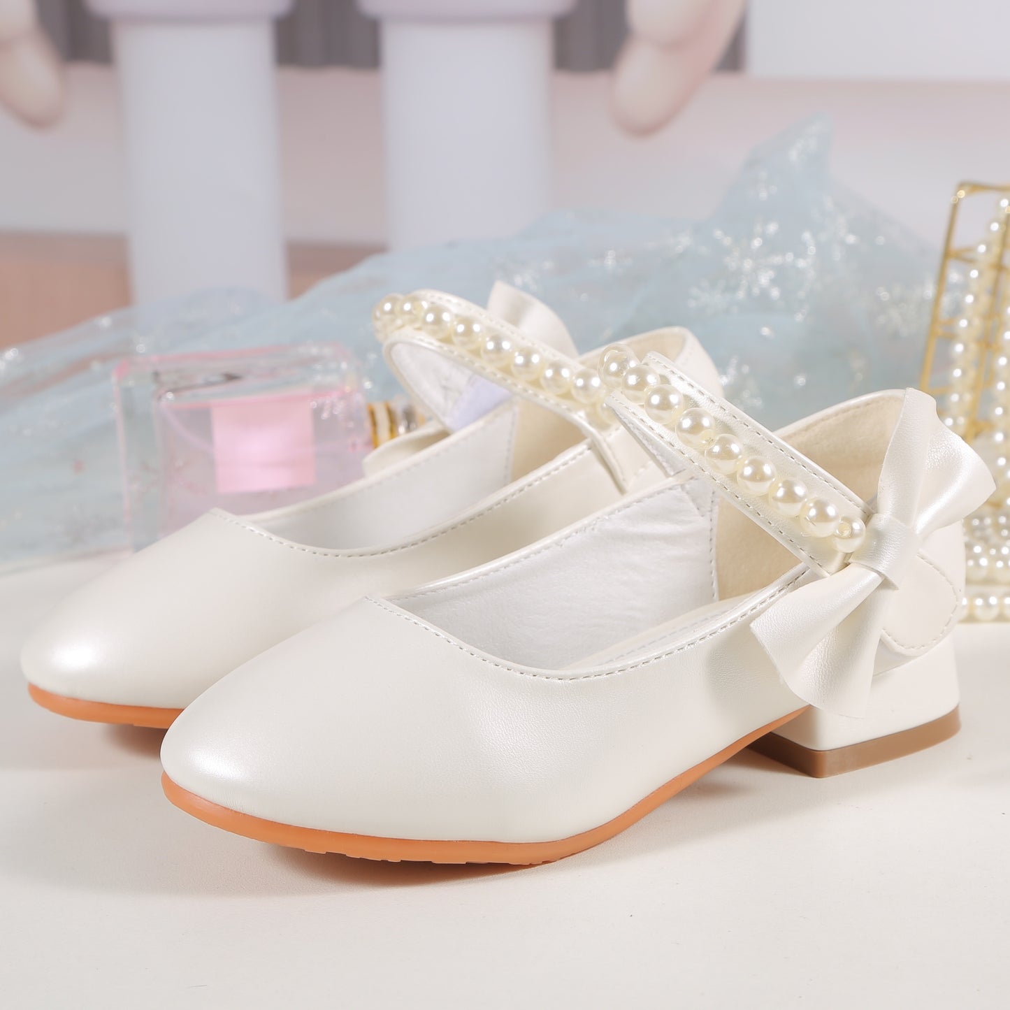 Princess high heels for girls with pearl accents and bowknot. Breathable and non-slip, perfect for school, parties, and formal events. White synthetic material with chunky heel and round