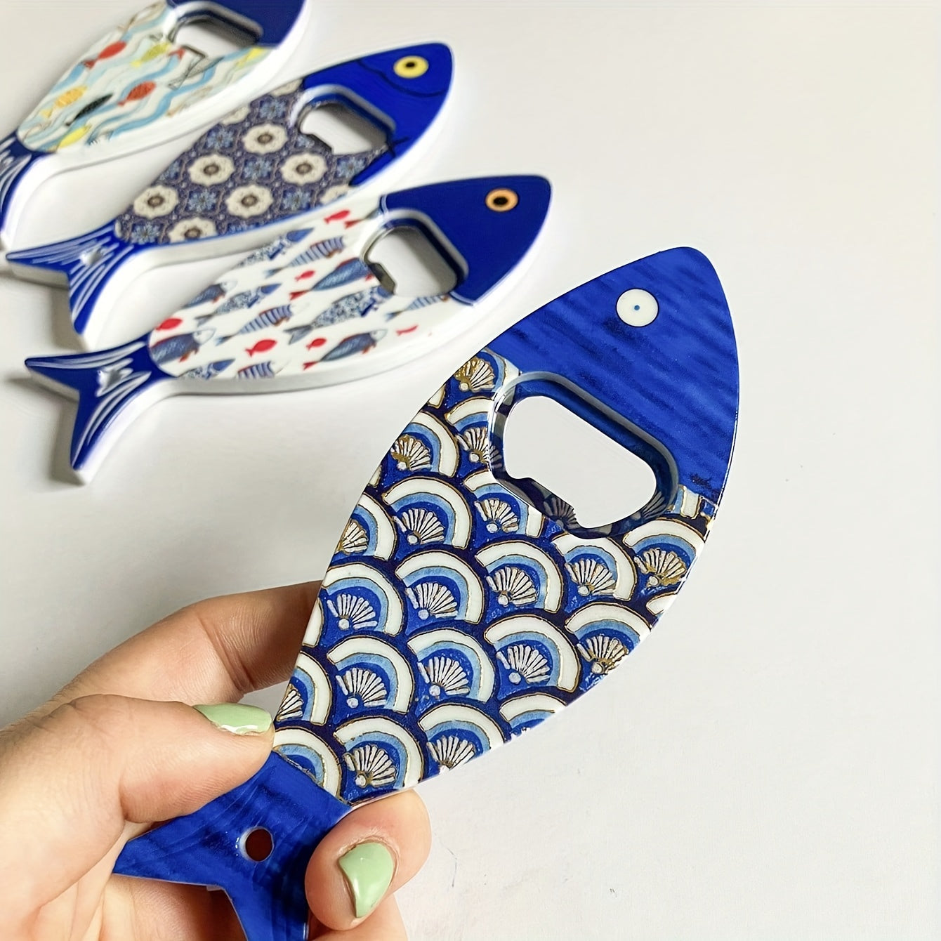 Fish-shaped cap opener with magnet for refrigerator decoration, no power required.