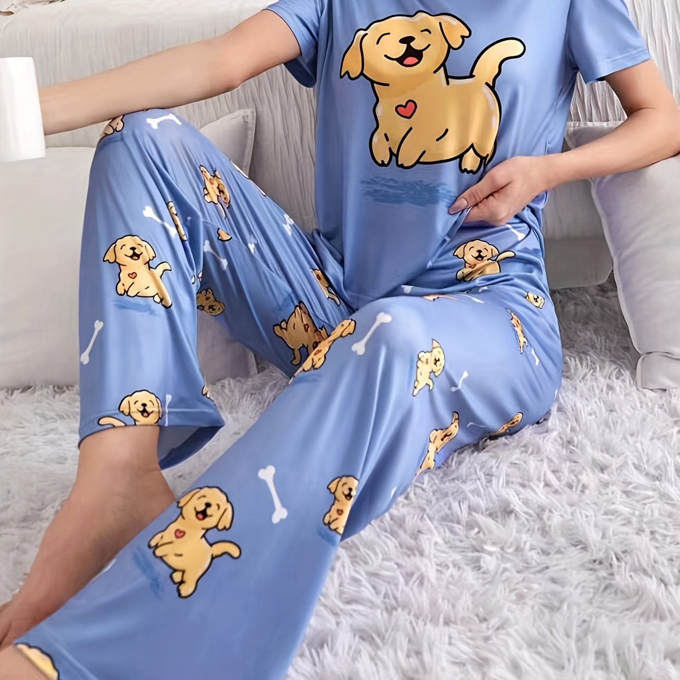 Women's sleepwear set with cute puppy print, short sleeve top, and elastic pants.