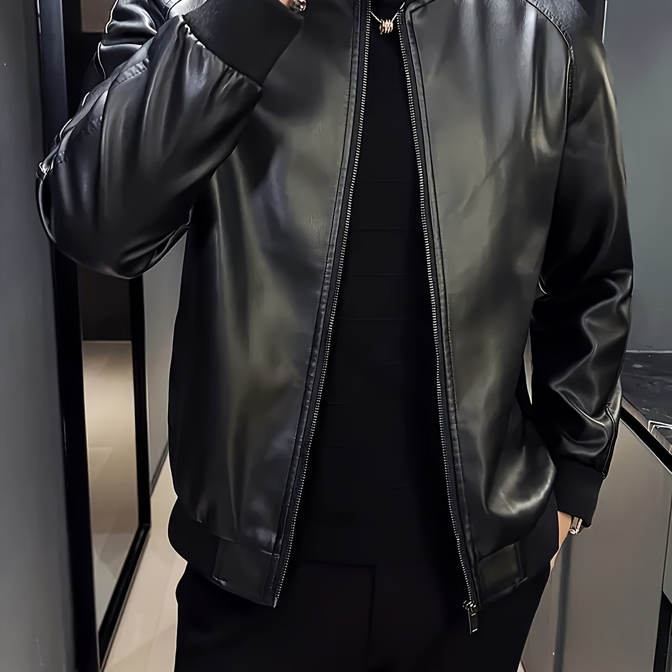 Stylish men's black PU leather jacket with casual baseball collar, zip-up pockets, loose fit, and machine washable - perfect for casual attire.