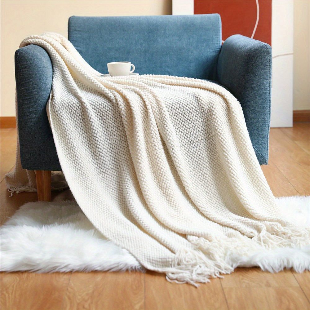 Stay cozy and stylish with this elegant knit throw blanket, featuring tassels for added flair. Made of lightweight acrylic with a bubble textured design, this blanket offers all-season comfort. Perfect for use on the couch, bed, or as home decor, as well