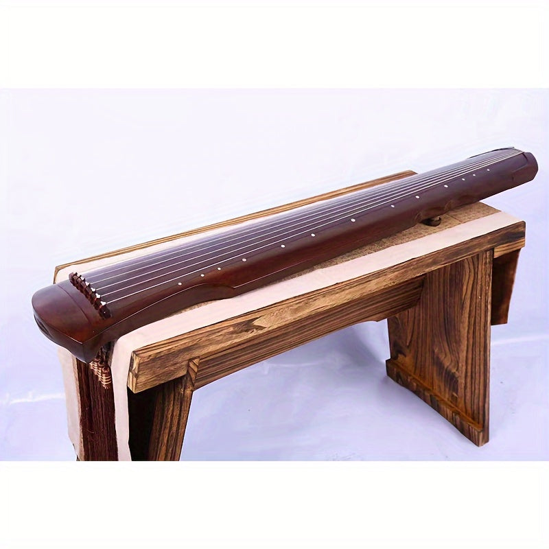 NUNUGGS Traditional Chinese Guqin made of solid paulownia wood with elegant black finish and golden tone tuning pins. Suitable for beginners, photo props, and antique interpretation.