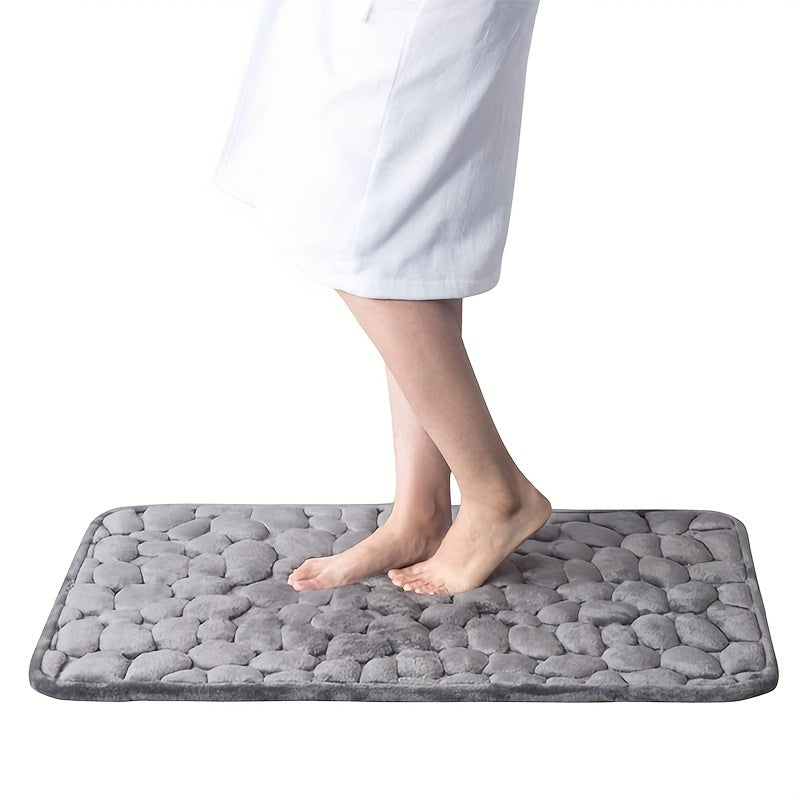 Soft, non-slip bath rug with excellent absorbency; machine washable with oblong shape and low pile.