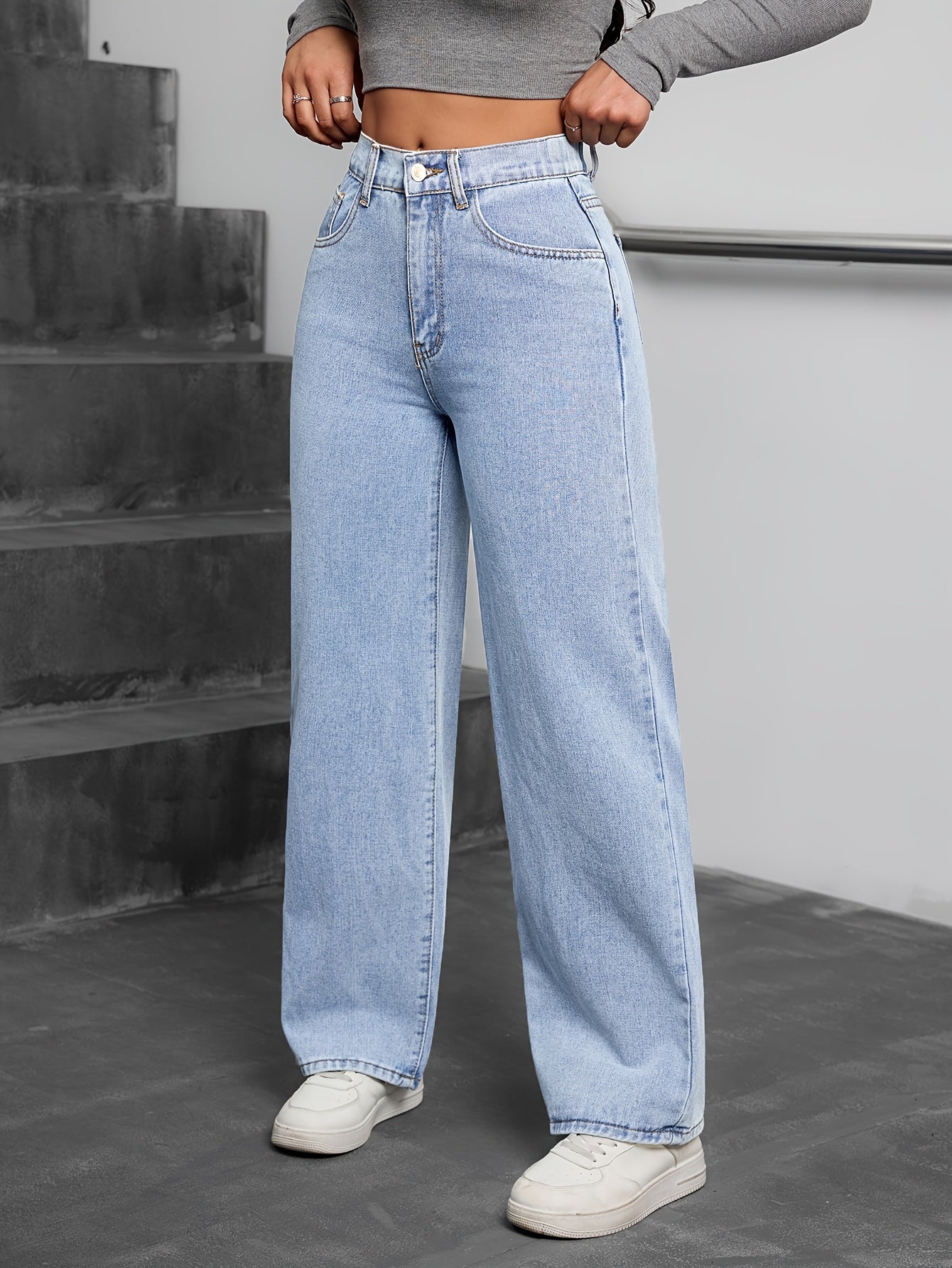 Simple washed blue denim pants for women, casual and basic style.