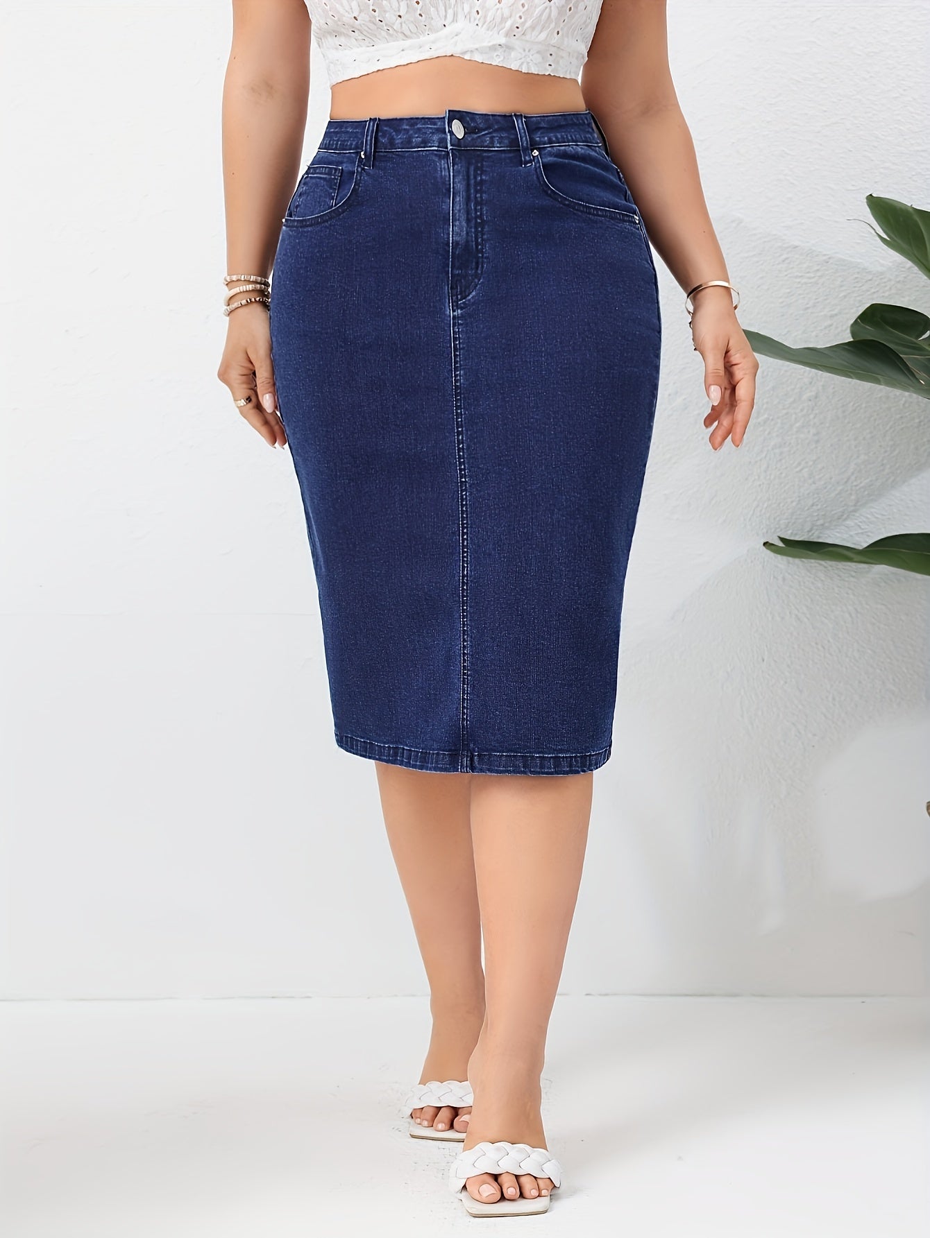 Blue washed high rise plus size bodycon denim skirt with slash pockets for women.