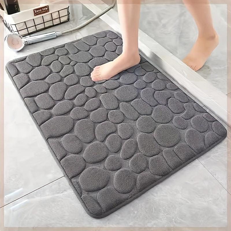 Upgrade your bathroom with the luxurious 1PC Pebble Embossed Memory Foam Bath Mat. This quick-drying carpet not only adds a touch of elegance to your living room but also provides a comfortable and washable non-slip surface for your bathroom. Elevate