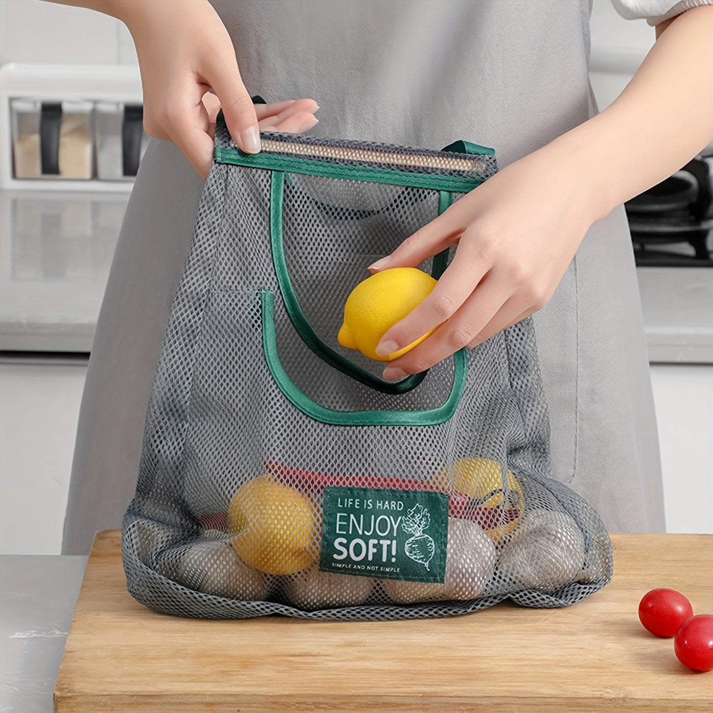 One piece of a mesh hanging bag ideal for storing a variety of items, including garlic, ginger, onion, fruits, and vegetables. This breathable and hangable bag is a versatile storage solution for your kitchen supplies.