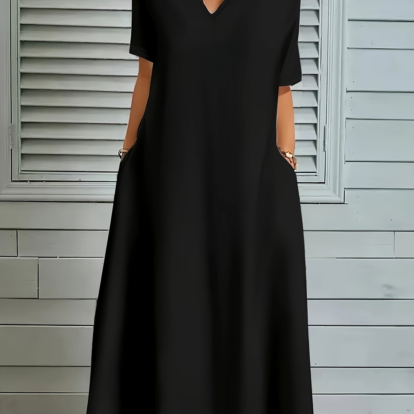 Plus size V-neck dress in solid color polyester knit with long flared hem. Medium stretch, pullover style with pocket detail for casual fall/winter wear.