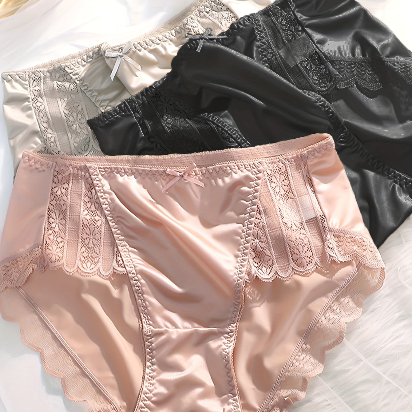 3 elegant satin briefs with lace trim for women, made of breathable polyamide and elastane blend.