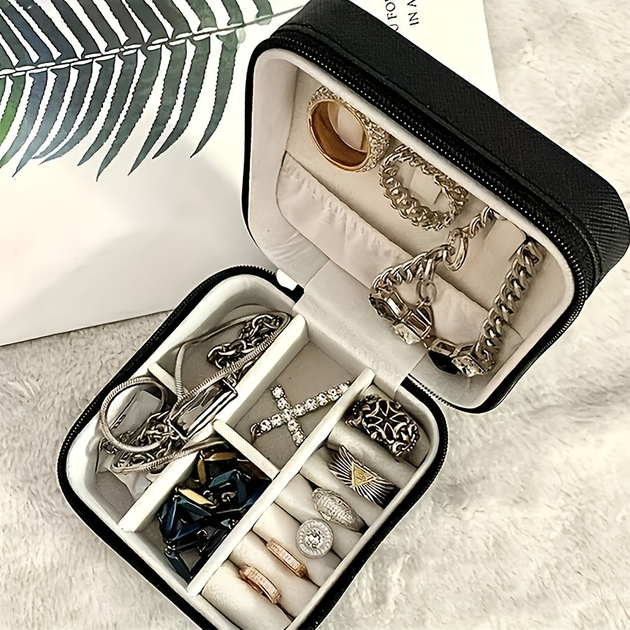 Stylish Jewelry Organizer for Women - Travel-friendly case with multiple compartments for necklaces, earrings, rings, and bracelets. Chic design with black exterior and pink interior. Soft