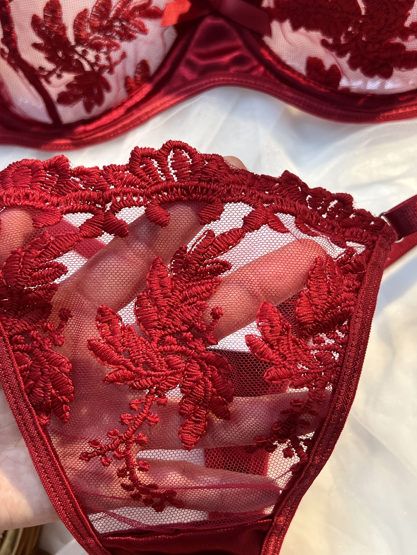 Floral embroidered lingerie set in burgundy, made from 97% polyester and 3% elastane knit fabric. Features medium support, no padding, thong panty, and drop waist - perfect as a Valentine's