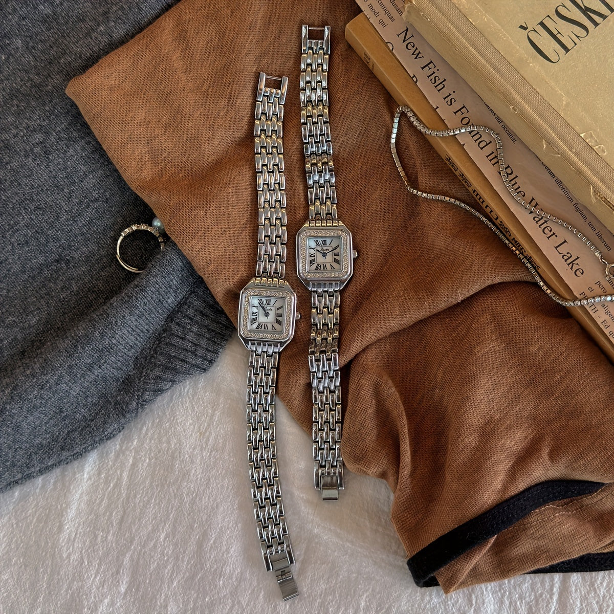 Gold-toned square watch with water drops and Roman numerals, suitable for any occasion.