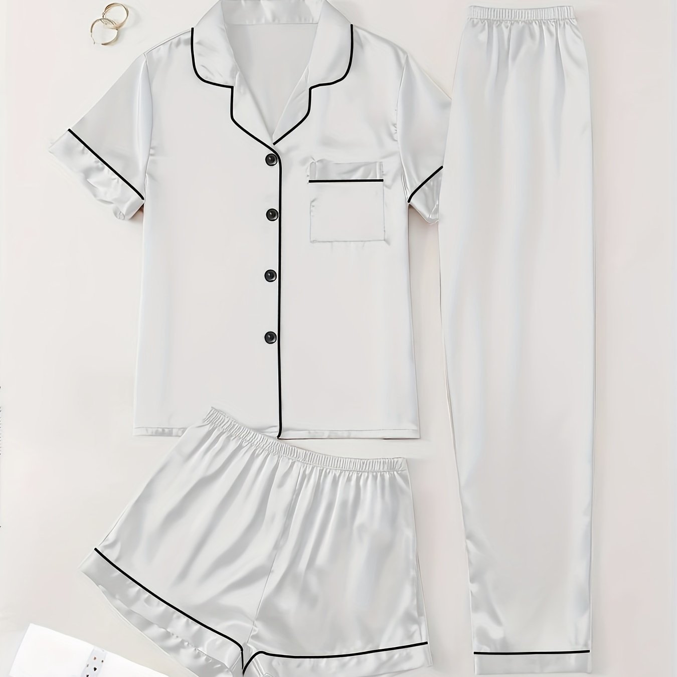 3-piece summer satin pajama set for women featuring collared shirt, long pants, and shorts. Made of 95% polyester and 5% elastane. Available in sizes S-XL.