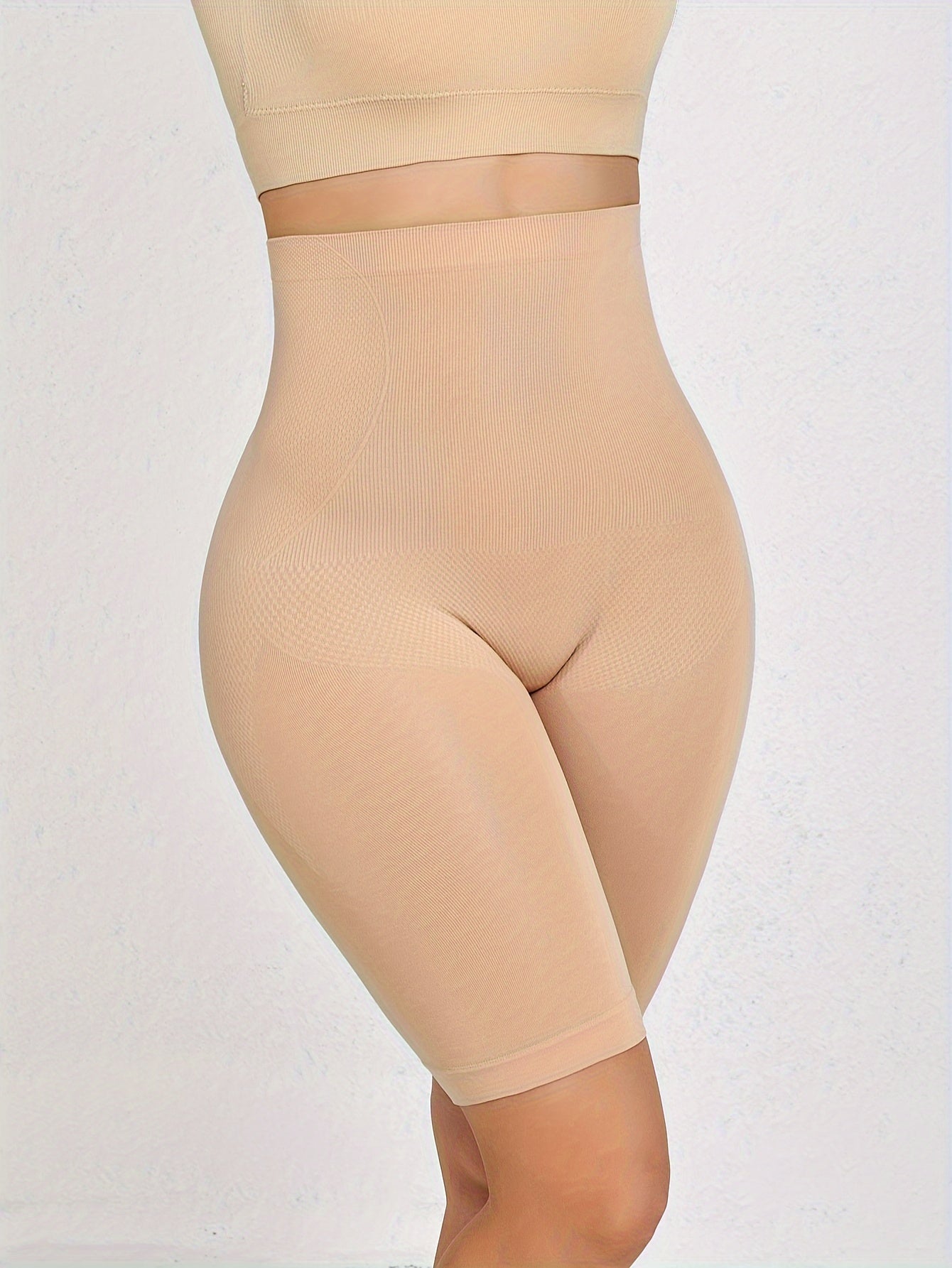 Seamless tummy control panties with waist cincher and butt lifter features, made from nylon and elastane blend.