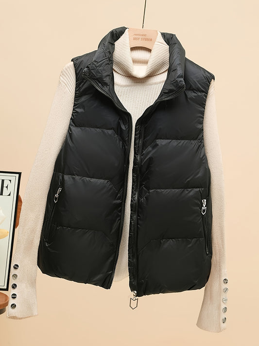 Sleeveless beige duck down vest with side pockets and zip-up closure. Perfect for fall/winter layering with a loose fit and 80g white duck down fill. Made of polyester with a glossy finish.