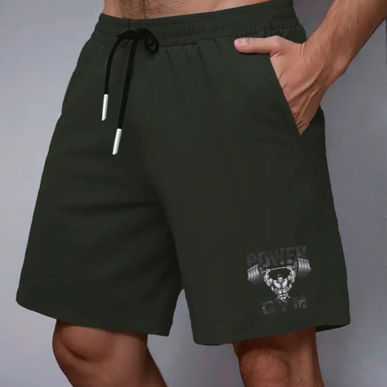 Power Gym Men's casual shorts made of 100% polyester non-stretch woven fabric. Features regular fit with pockets and a muscular barbell print. Big and tall sizes, plus sizes available.