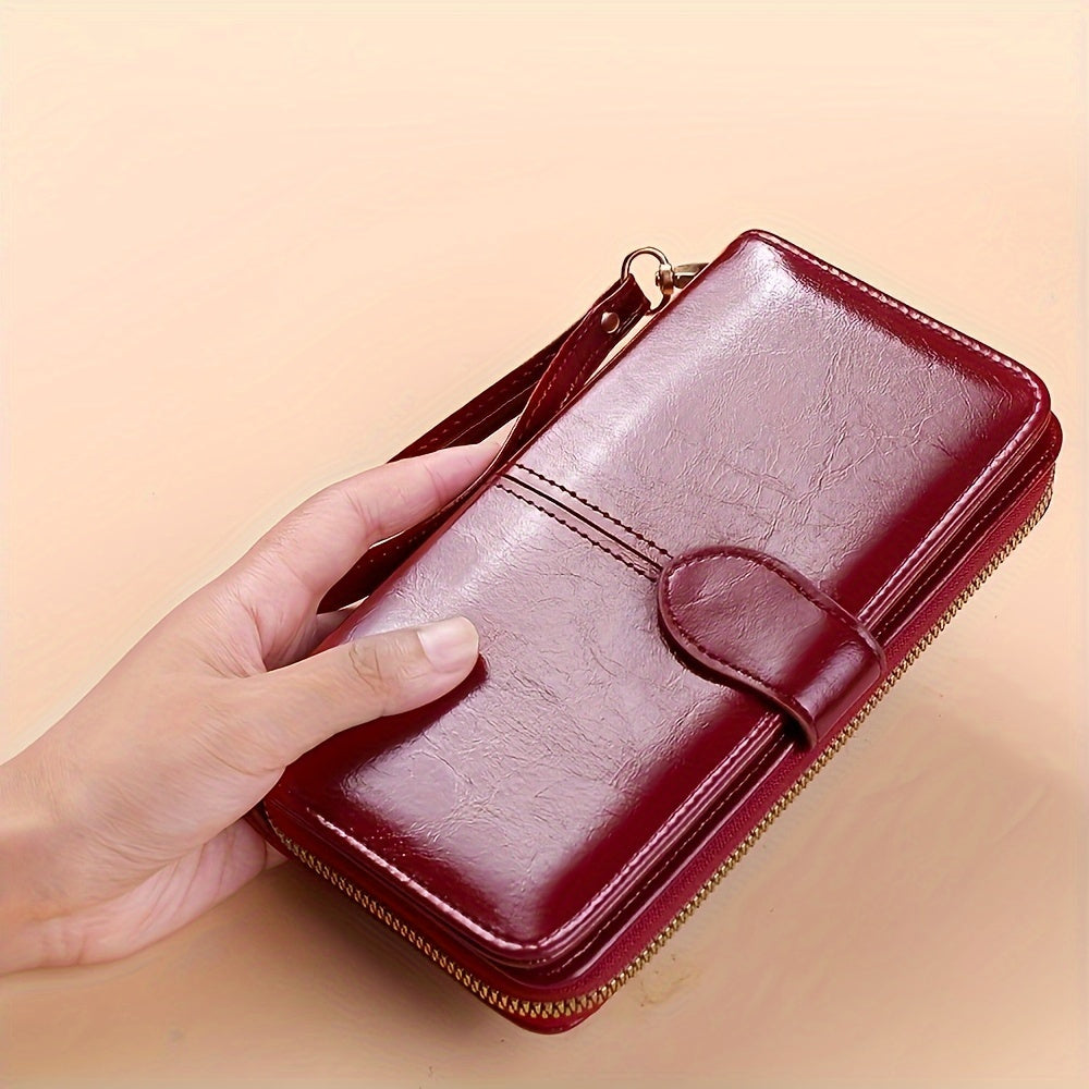 Red synthetic leather wallet with wrist strap, large capacity for cards, zipper closure, polyester lining - ideal for everyday use, contemporary and durable.