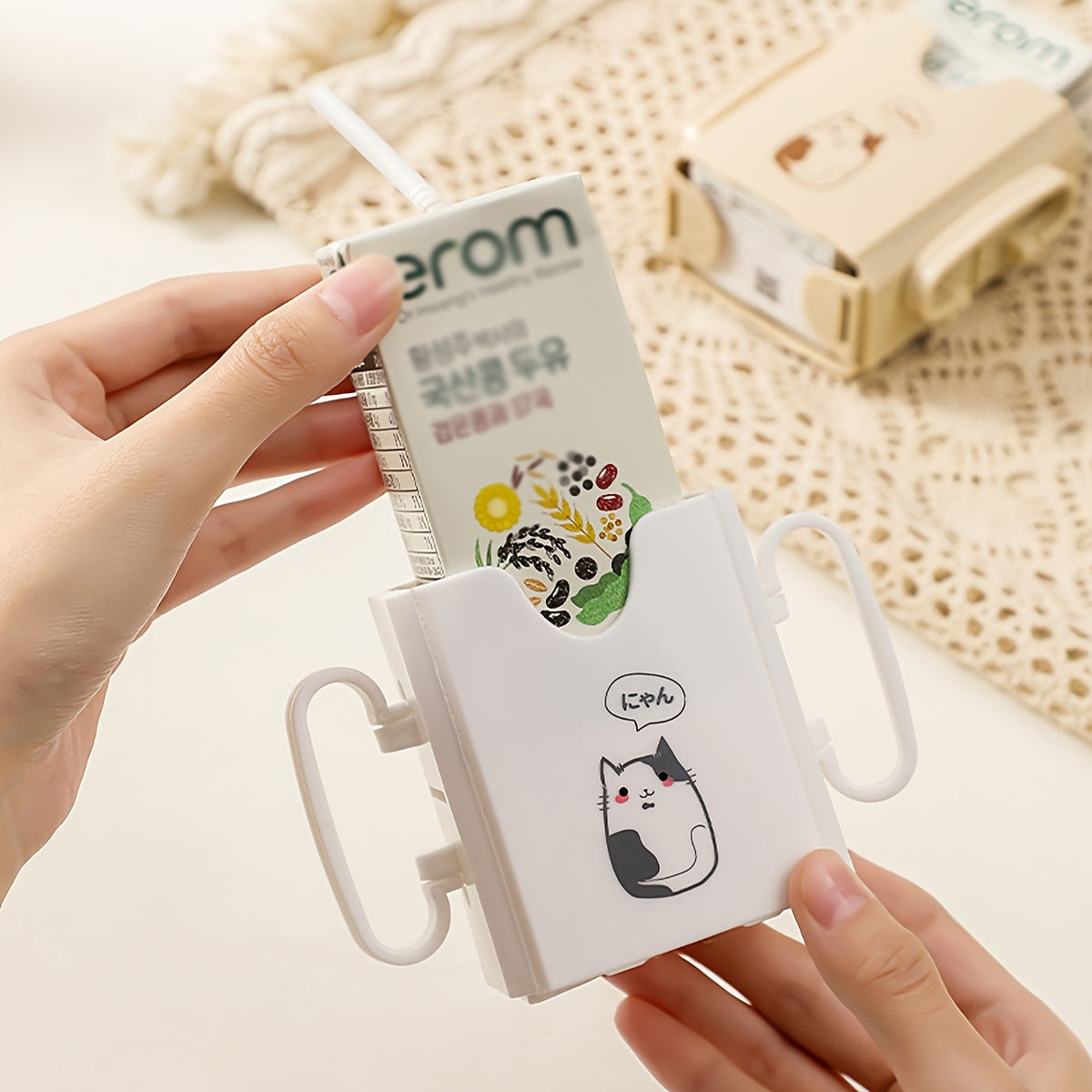 Milk carton holder featuring a cute cat design, made with spill-proof polycarbonate material. This drink support bracket is food contact safe and keeps beverages upright.