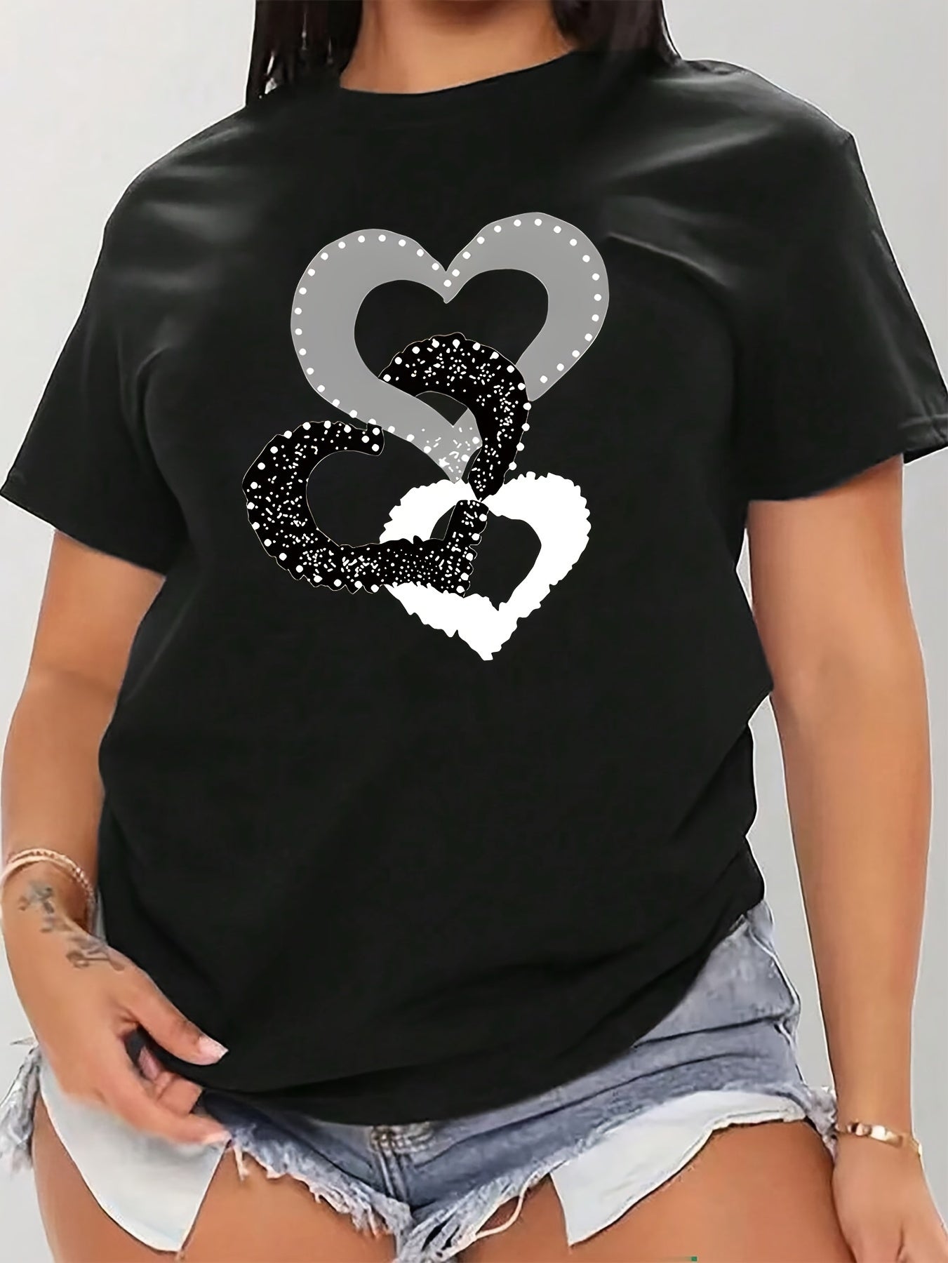 Black heart graphic tee in plus size, soft touch, chic design, crew neck, short sleeve, stretchy polyester blend, machine washable.