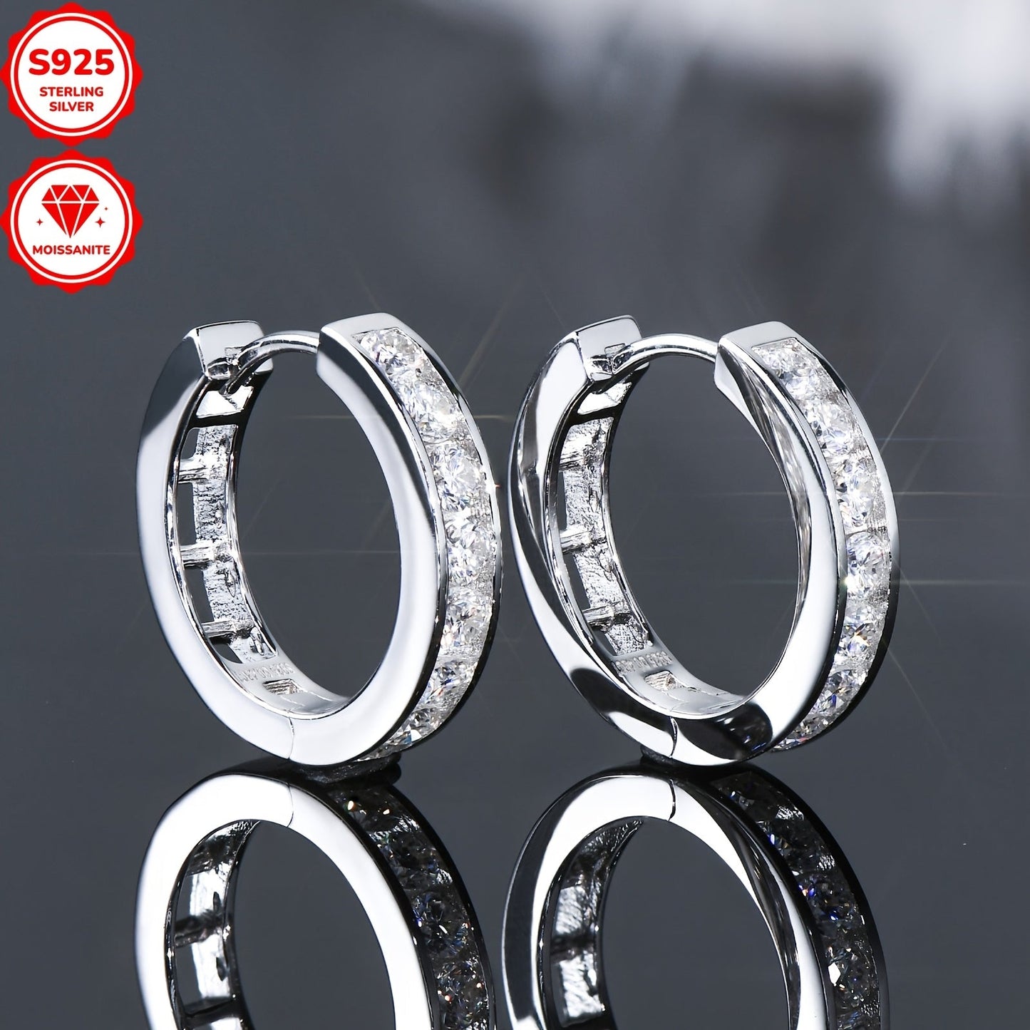 These stunning hoop earrings are crafted from 925 sterling silver and feature dazzling D color 2.5mm round moissanite stones in a track setting. The inner diameter of the earrings is 13mm, and they come with a GRA certificate. The total weight of the